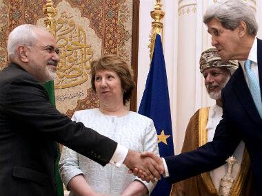 U.S. Secretary of State John Kerry, right, and Iranian Foreign Minister Mohammad Javad Zarif, shake hands during a meeting in Muscat, Oman. AP 