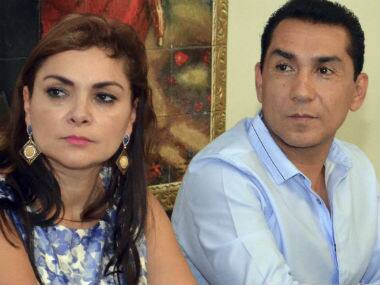 the mayor of the city of Iguala, Jose Luis Abarca, right, and his wife Maria de los Angeles Pineda Villa meet with state government officials in Chilpancingo, Mexico. AP 