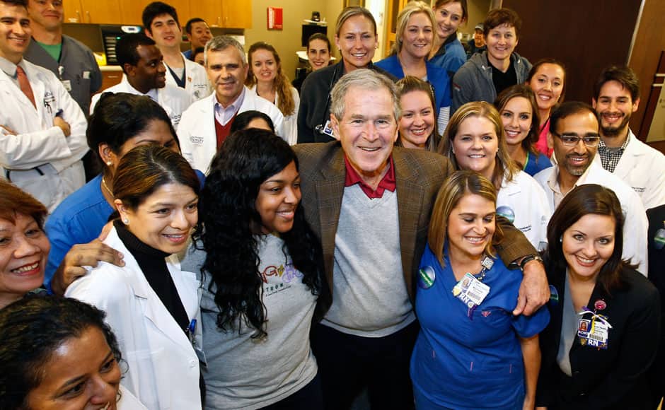 In this photo provided by Texas Health Resources, former President George W. Bush poses with caregivers in the Medical Intensive Care Unit at Texas Health Presbyterian Hospital, Friday, Nov. 7, 2014, in Dallas. Bush has marked the end of the Ebola crisis in Dallas by visiting the hospital where a man died of the disease and two nurses became infected. (AP Photo/Texas Health Resources)