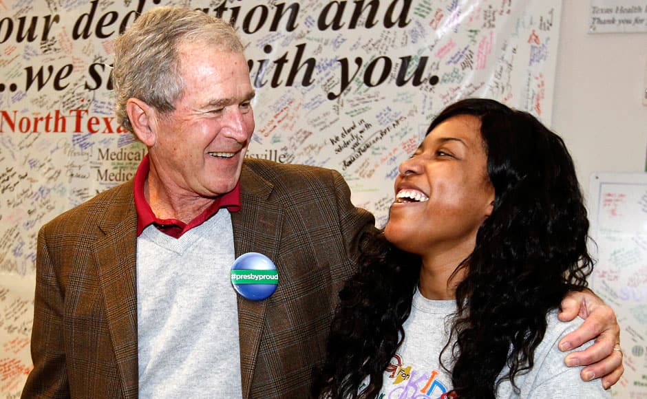 In this photo provided by Texas Health Resources, former President George W. Bush hugs nurse and Ebola survivor Amber Vinson at Texas Health Presbyterian Hospital, Friday, Nov. 7, 2014, in Dallas. Bush has marked the end of the Ebola crisis in Dallas by visiting the hospital where a man died of the disease and two nurses became infected. (AP Photo/Texas Health Resources)