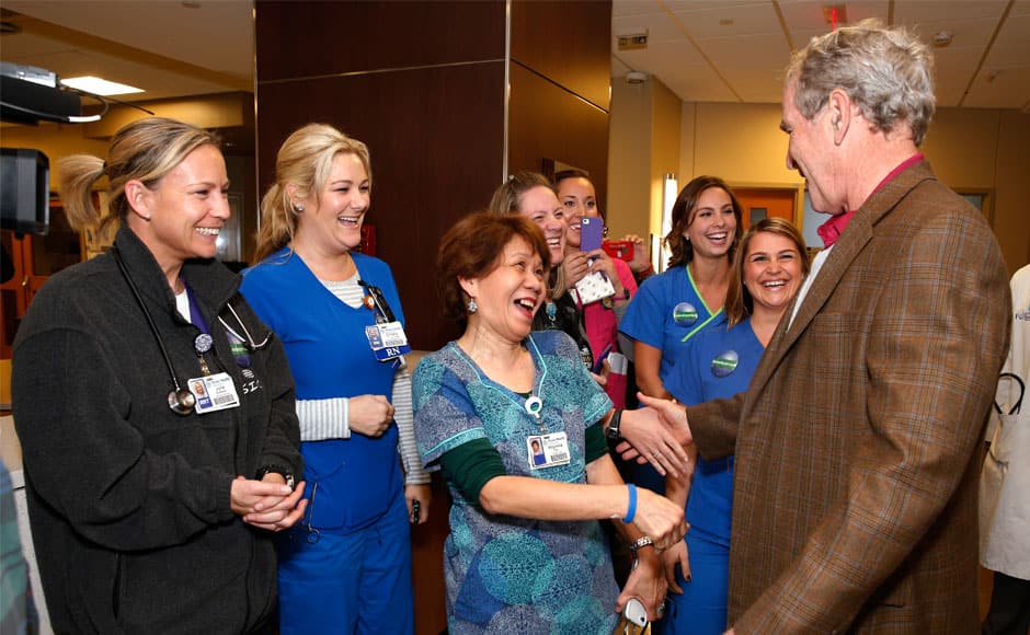 Former President George W. Bush greets hospital staff, Friday, Nov. 7, 2014, at Texas Health Presbyterian Hospital of Dallas. The city calmly marked the end of its Ebola crisis on Friday, when the last of the 177 people who were being monitored for symptoms of the deadly virus were to be cleared at midnight. (AP Photo/The Dallas Morning News, David Woo)