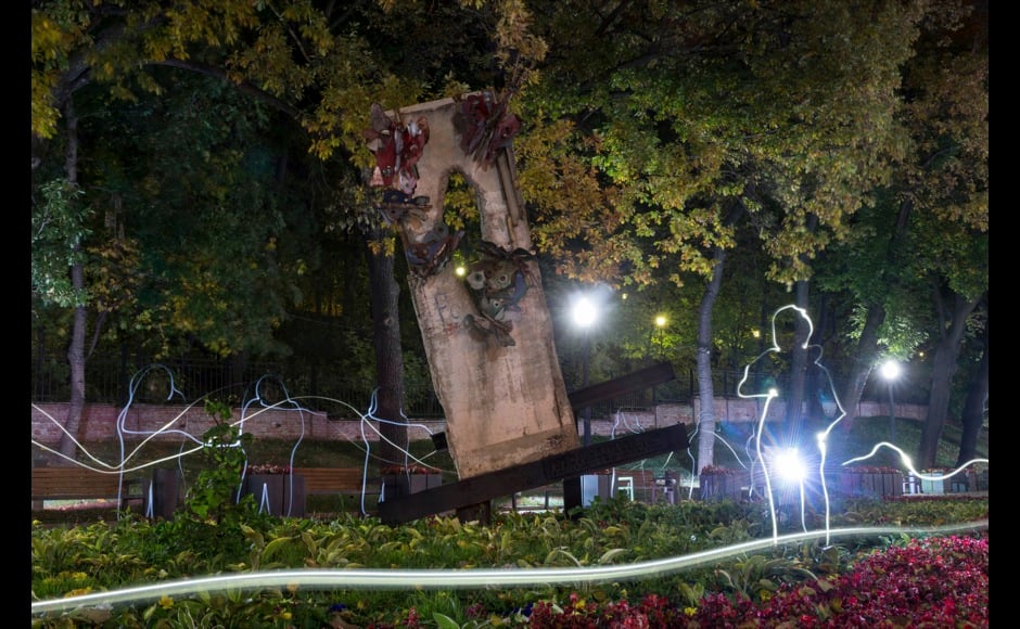 A piece of the Berlin Wall is seen in a park in central Moscow October 8, 2014. On November 9, Germany will celebrate the 25th anniversary of the fall of the Berlin Wall. To mark the event Reuters Photographers around the world captured images of segments of the wall, which are kept as monuments in many countries from Taiwan to South Africa and Costa Rica. The Berlin Wall, which divided West Berlin from the communist East after it was built in 1961, was the most potent symbol of the Cold War. At least 136 people were killed or died at the Wall, most of them while trying to escape. On November 9, 1989, following huge protests in East Berlin the wall was breached and thousands of people poured into West Berlin. Picture taken October 8, 2014. Picture was taken using light painting and a long exposure. REUTERS/Maxim Shemetov (RUSSIA - Tags: SOCIETY ANNIVERSARY CONFLICT TPX IMAGES OF THE DAY) ATTENTION EDITORS - PICTURE 12 OF 32 FOR WIDER IMAGE STORY 'THE BERLIN WALL AROUND THE WORLD' SEARCH '25 BERLIN' FOR ALL IMAGES - RTR4CLOQ