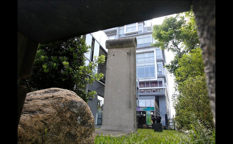 A piece of the Berlin Wall is seen in the front yard of the Taiwan Foundation for Democracy in Taipei October 20, 2014. On November 9, Germany will celebrate the 25th anniversary of the fall of the Berlin Wall. To mark the event Reuters Photographers around the world captured images of segments of the wall, which are kept as monuments in many countries from Taiwan to South Africa and Costa Rica. The Berlin Wall, which divided West Berlin from the communist East after it was built in 1961, was the most potent symbol of the Cold War. At least 136 people were killed or died at the Wall, most of them while trying to escape. On November 9, 1989, following huge protests in East Berlin the wall was breached and thousands of people poured into West Berlin. Picture taken October 20, 2014. REUTERS/Pichi Chuang (TAIWAN - Tags: SOCIETY ANNIVERSARY CONFLICT) ATTENTION EDITORS - PICTURE 19 OF 32 FOR WIDER IMAGE STORY 'THE BERLIN WALL AROUND THE WORLD' SEARCH '25 BERLIN' FOR ALL IMAGES - RTR4CLPA