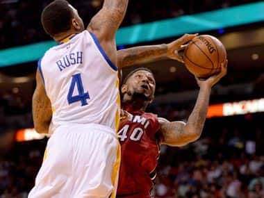 Miami Heat forward Udonis Haslem drives to the basket as Golden State Warriors guard Brandon Rush defends during the second half. Reuters 
