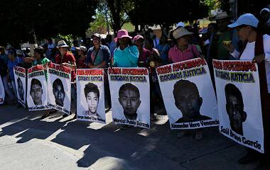 Relatives hold pictures of missing students. Reuters