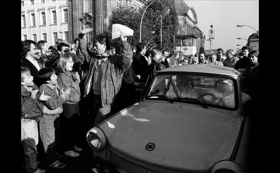 FILE PHOTO 10NOV89 - West Berlin citizens welcome East Germans who passed the border checkpoint Invaliden Strasse with an East German Trabant car after the opening of the East German border was announced in this November 10, 1989 file photo. The 10th anniversary off the 