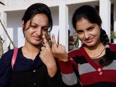 Girls show their inked fingers after casting votes at a polling station for the first phase of J & K Assembly elections at Jagti Township in Jammu on Tuesday. PTI 