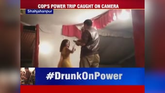 Drunk UP cop throws money at dancer, forces her to perform at gunpoint