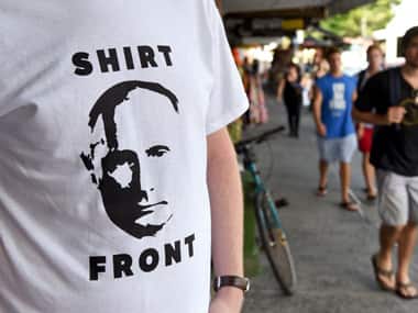Folks sporting shirtfront T-shirt after Abbott's statements. AFP
