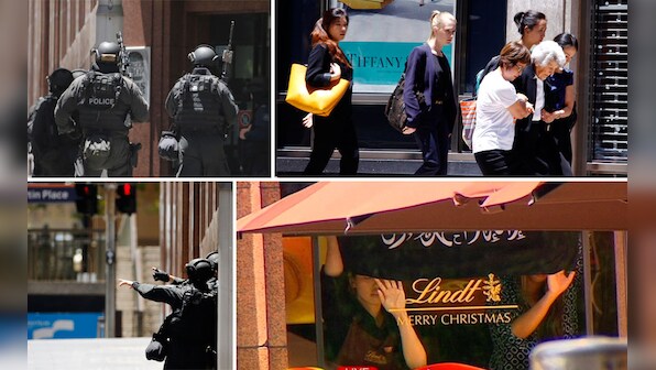  Sydney siege: Hostages held in a cafe, made to hold up Islamic flags