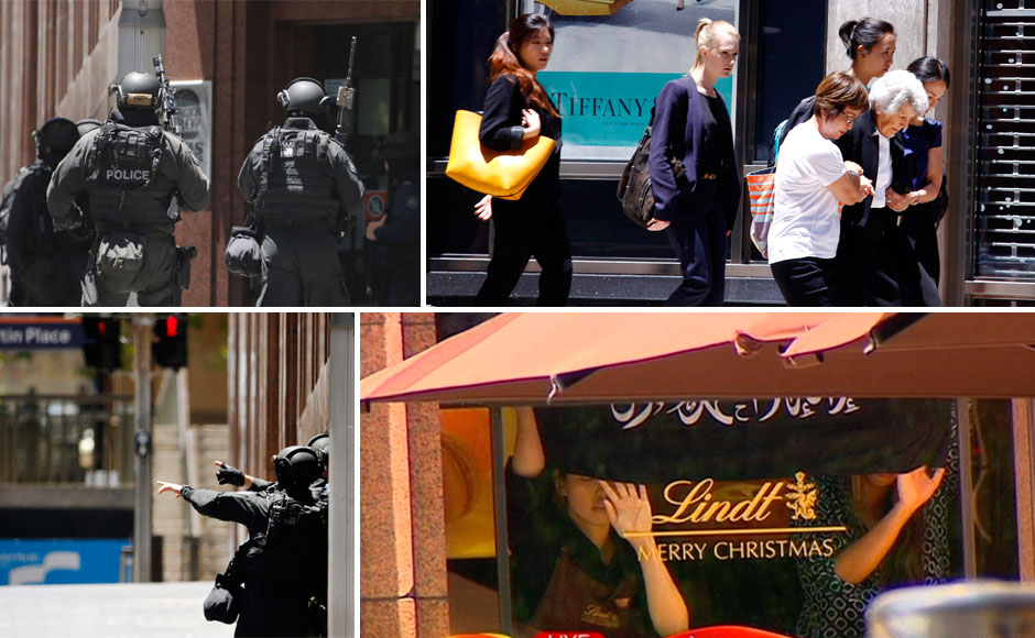 Sydney siege: Hostages held in a cafe, made to hold up Islamic flags Sydney siege: Hostages held in a cafe, made to hold up Islamic flags
