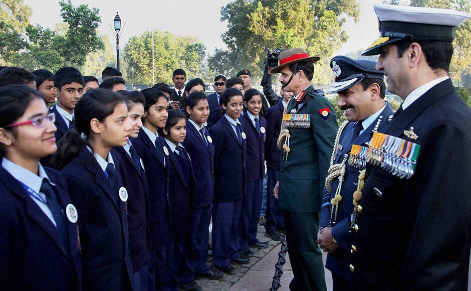 New Delhi: Services chiefs interacts with the students during the wreath laying ceremony at AJJ on the occasion of Navy Day in New Delhi on Thursday. PTI 