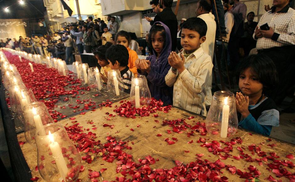 Pakistani children, chant prayers, during a candle light vigil for the victims of a Taliban attack on a school in Peshawar, organized by supporters of the Mutahida Qaumi Movement (MQM), in Karachi, Pakistan, Tuesday, Dec. 16, 2014. Taliban gunmen stormed a military-run school in the northwestern Pakistani city of Peshawar on Tuesday, killing more than 100, officials said, in the highest-profile militant attack to hit the troubled region in months. (AP Photo/Fareed Khan)