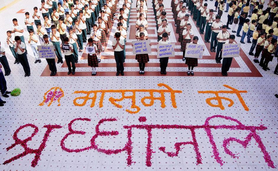 Ahmedabad: School children in Ahmedabad pray as they pay tributes to the children killed in Pakistan terror attack, on Wednesday. PTI
