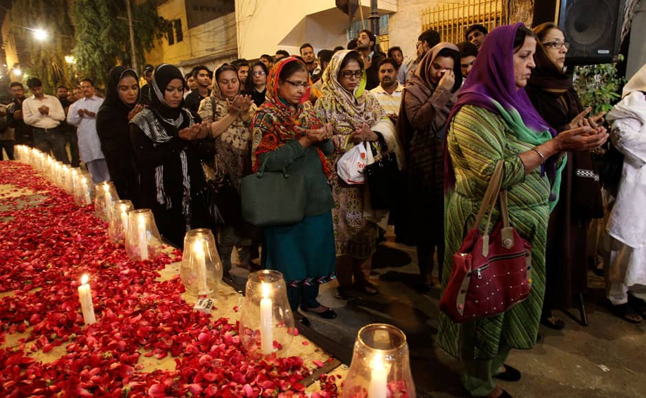 Supporters of the Mutahida Qaumi Movement (MQM), chant prayers, during a candle light vigil for the victims of a Taliban attack on a school, in Karachi, Pakistan, Tuesday, Dec. 16, 2014. Taliban gunmen stormed a military-run school in the northwestern Pakistani city of Peshawar on Tuesday, killing more than 100, officials said, in the highest-profile militant attack to hit the troubled region in months. (AP Photo/Fareed Khan)