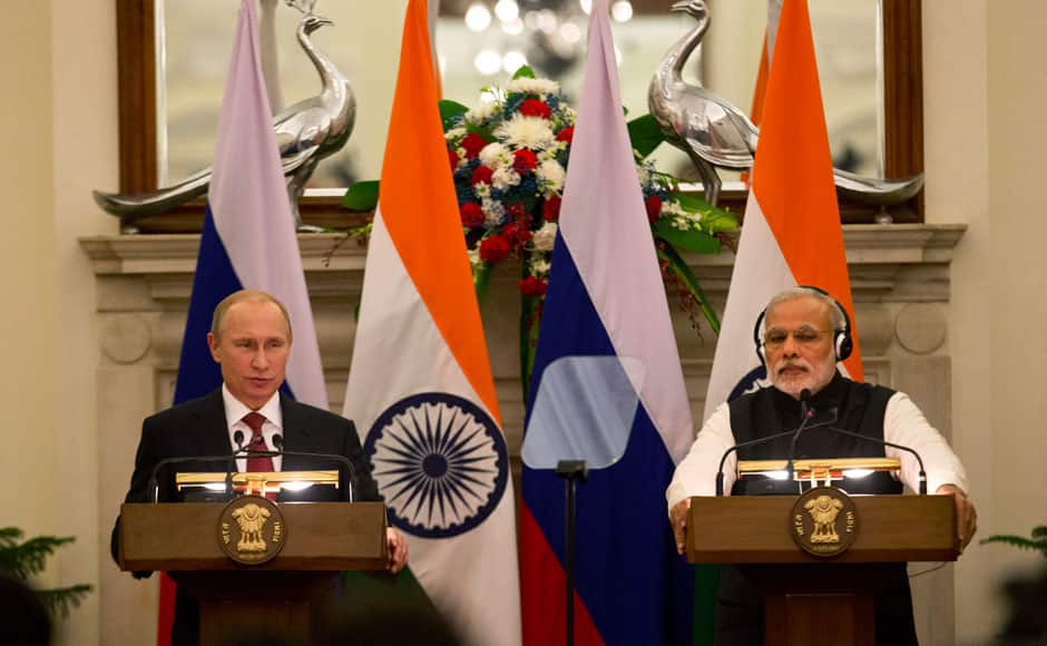 Russian President Vladimir Putin, left, makes a statement as India's Prime Minister Narendra Modi listens after delegation level talks and signing of agreements in New Delhi, India, Thursday, Dec. 11, 2014. Putin was holding talks with Indian leaders Thursday to strengthen trade and energy cooperation with Asia's third-largest economy as Western sanctions threaten to push his country's economy to the brink of a recession. (AP Photo /Manish Swarup)