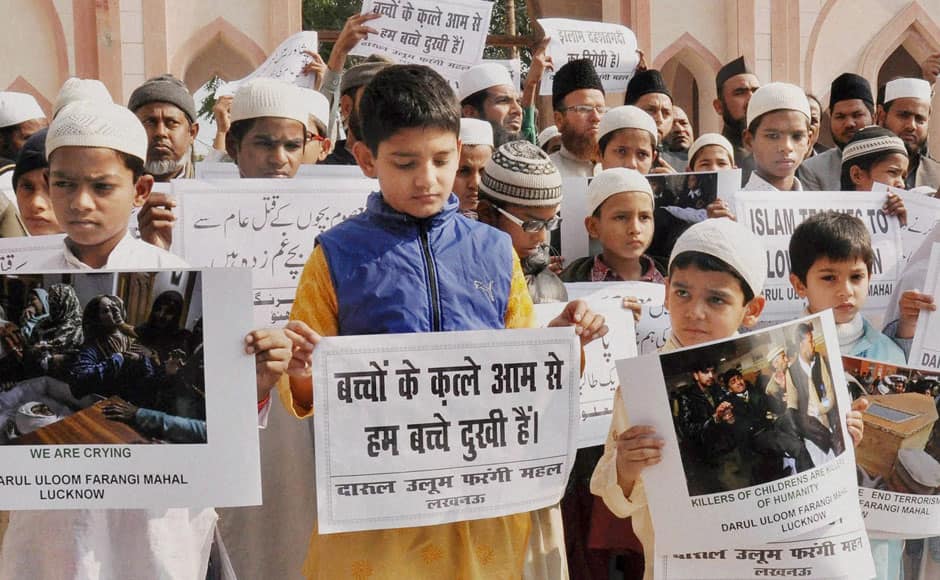 Lucknow: Muslim students hold placards during a protest at Eidgah in Lucknow on Wednesday to condemn the Peshawar Army school terror attack in Pakistan. PTI 