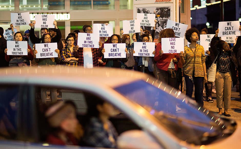 Protesters hold signs in Atlanta on Thursday, Dec. 4, 2014 during a demonstration against the deaths of two unarmed black men at the hands of white police officers in New York City and Ferguson, Mo. AP
