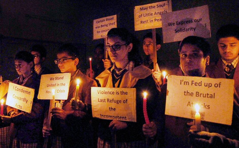 Amritsar:-Holding candles in their hand and placard School children on Wednesday observing two minute silence in remembrance of the young children killed by terrorists in one of the most ghastly attack in Peshawar, Pakistan, in Amritsar on Wednesday.PTI