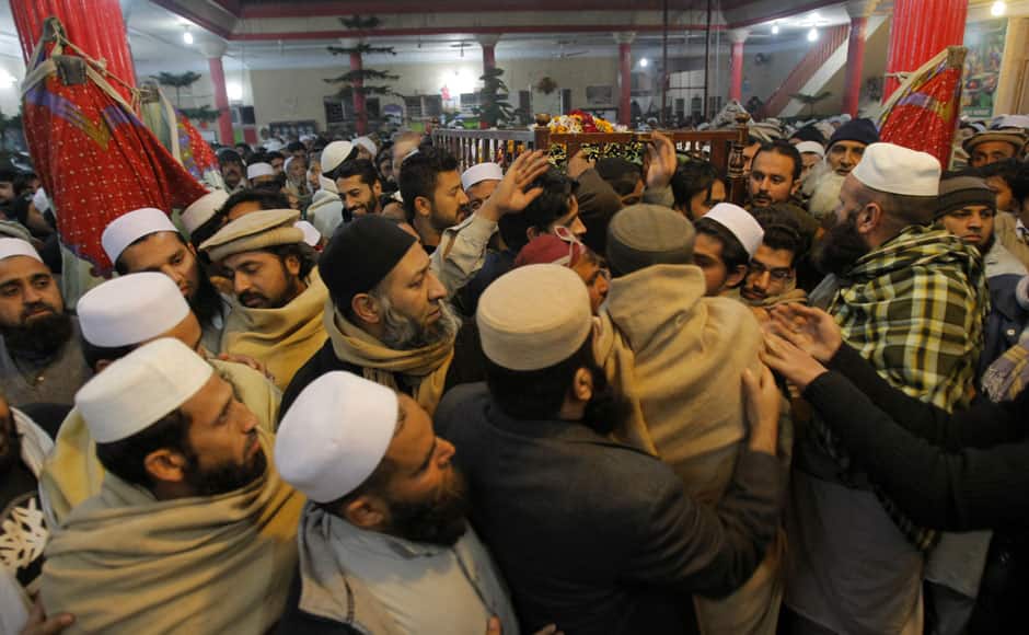 Mourners and relatives of Pakistani teacher, Saeed Khan, a victim of a Taliban attack in a school, carry his body, during his funeral procession in Peshawar, Pakistan, Tuesday, Dec. 16, 2014. Taliban gunmen stormed a military-run school in the northwestern Pakistani city of Peshawar on Tuesday, killing at least 100 people, mostly children, before Pakistani officials declared a military operation to clear the school over. (AP Photo/Mohammad Sajjad)