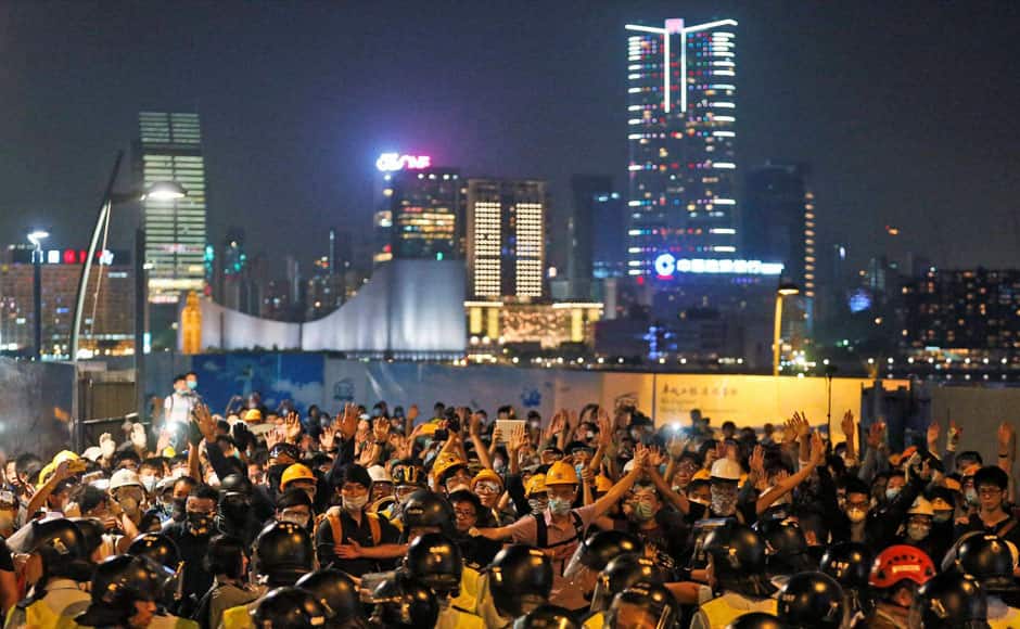 Hong Kong : Pro-democracy protesters scuffle with police officers on the main road outside the government headquarters in Hong Kong Sunday, Nov. 30, 2014. Hundreds of pro-democracy protesters faced off with Hong Kong police late Sunday, stepping up their movement for genuine democratic reforms after being camped out on the city's streets for more than two months. AP/ PTI