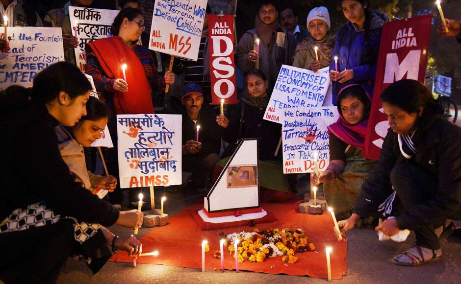 New Delhi : Members of All India Democratic Students' Organisation light candles to pay tribute to victims of the Pakistan terror attacks in New Delhi on Wednesday. PTI