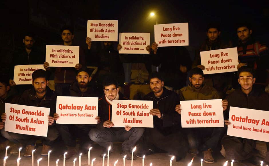 Srinagar: Students hold placards during a candle light protest against the Pakistan terror attacks in Srinagar on Wednesday. PTI 