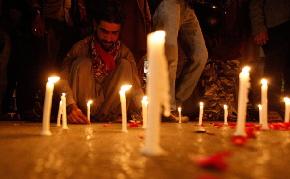 A man lights candles to mourn the victims from the Army Public School in Peshawar, which was attack by Taliban gunmen, in Karachi, December 16, 2014. Taliban gunmen in Pakistan took hundreds of students and teachers hostage on Tuesday in a school in the northwestern city of Peshawar, military officials said. REUTERS