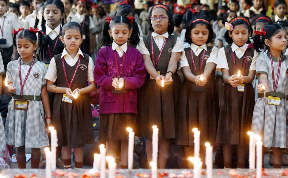 Mumbai: School Children pray in Mumbai on Wednesday during a candle light vigil for the victims of Taliban attack on a army school in Peshawar. PTI 