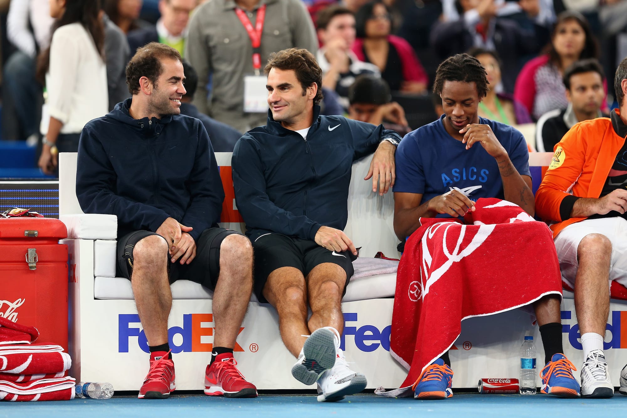 Pete Sampras and Roger Federer exchange strategies as Gael Monfils tries to eves drop. Getty Images