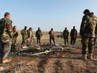 Kurdish Peshmerga forces inspect a site in Hardan village in northern Iraq, where Islamic State group fighters allegedly executed people from the Yazidi sect captured when they swept through the area in August. AP