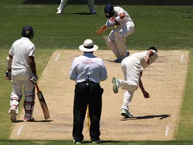 Virat Kohli being hit on the helmet by a Mitchell Johnson bouncer on day three of the first Test. Getty
