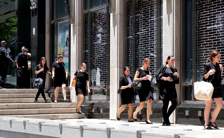 Police evacuate people from an office building close to the cafe. The NCW police said their top priority was the safety of innocent lives. AP
