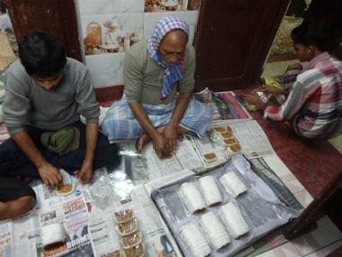 Saldanha wrapping a cake after it's been baked. Sandip Roy/ Firstpost