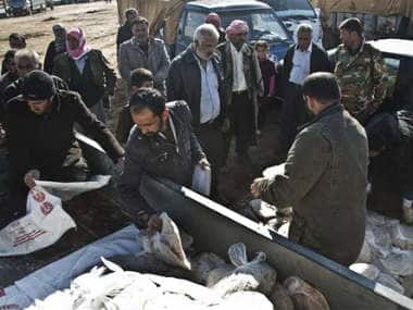 In this Saturday, Nov. 22, 2014 photo, bread is distributed by the Kurdish People’s Protection Units (YPG) in Kobani, Syria. AP 