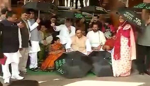 black umbrellas. IBNLive