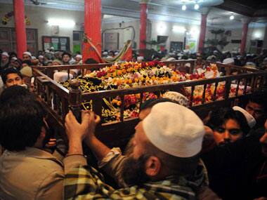 Mourners carry the coffin of a student killed in the attack. AFP.