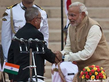 Pranab Mukherjee and Narendra Modi. AFP.