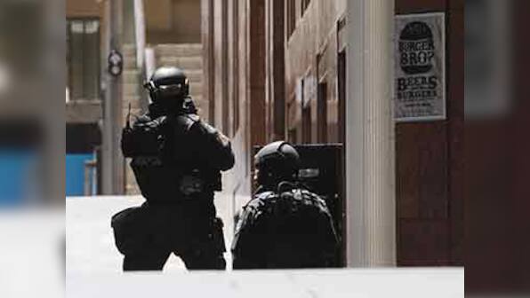 Dozens held hostage inside Sydney's Lindt cafe, forced to display Islamic flags