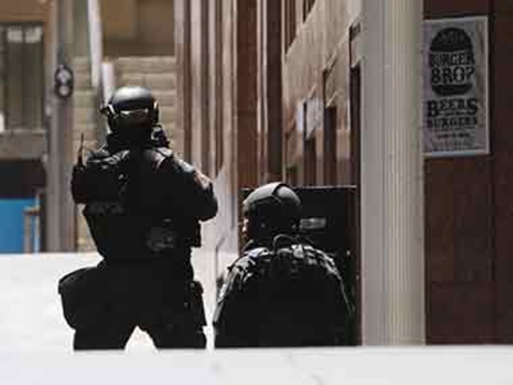 Dozens held hostage inside Sydney's Lindt cafe, forced to display Islamic flags