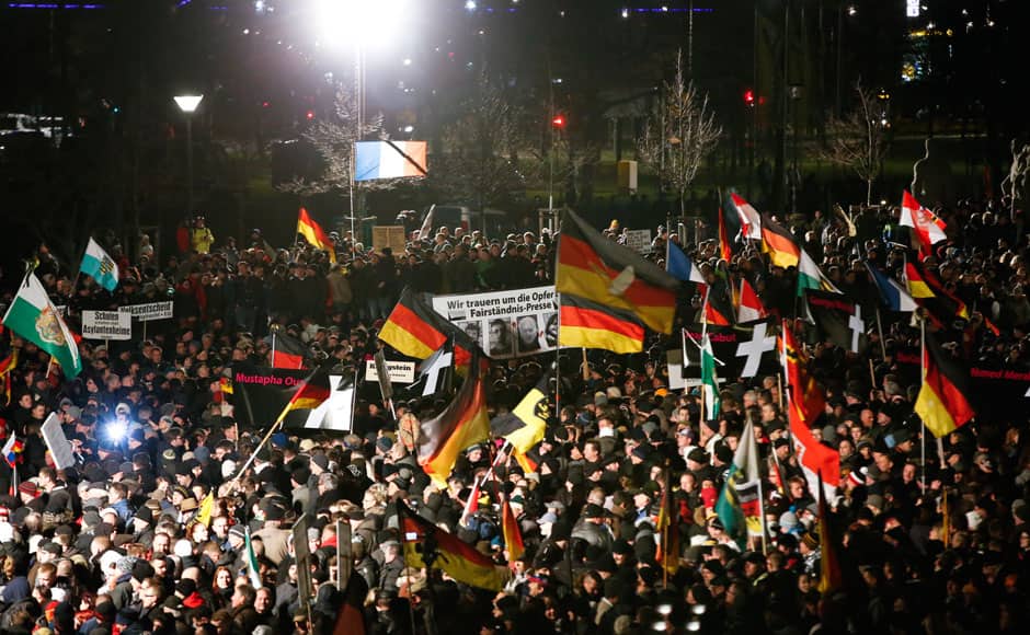 Supporters of anti-immigration movement Patriotic Europeans Against the Islamisation of the West (PEGIDA) hold flags during a demonstration in Dresden January 12, 2015. REUTERS