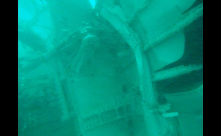 In this undated underwater photo released by Indonesia's National Search And Rescue Agency (BASARNAS) on Wednesday, Jan. 7, 2015, the part of the wreckage that BASARNAS identified as of the ill-fated AirAsia Flight 8501, is seen in the waters of the Java Sea, Indonesia. Divers and an unmanned underwater vehicle spotted the tail of the missing AirAsia plane in the Java Sea on Wednesday, the first confirmed sighting of any major wreckage 11 days after Flight 8501 disappeared with the passengers and crew members on board. (AP Photo/BASARNAS)
