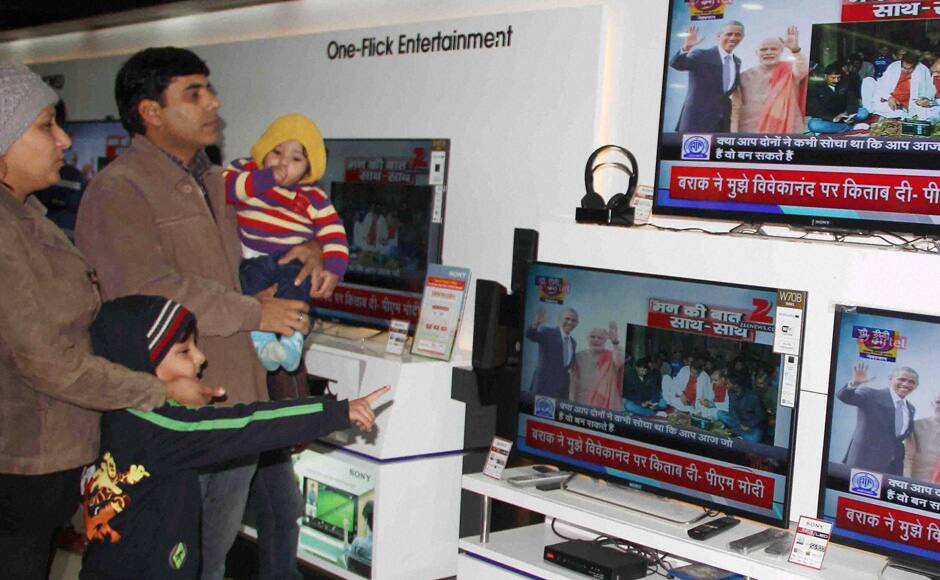 Allahabad: People watch the joint radio address of Prime Minister Narendra Modi and US President Barack Obama, ìSharing our ëMann Ki Baatí during its broadcast on Television and Radio at a shop in Allahabad on Tuesday. PTI 