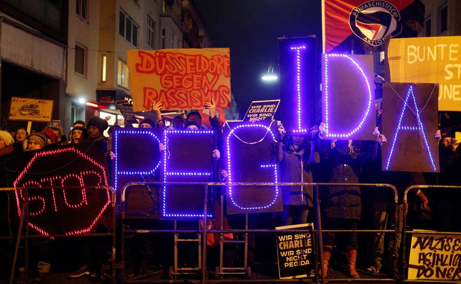 Protesters take part in an anti-racism demonstration against the anti-immigration movement Patriotic Europeans Against the Islamisation of the West (PEGIDA) in Duesseldorf, January 12, 2015. REUTERS