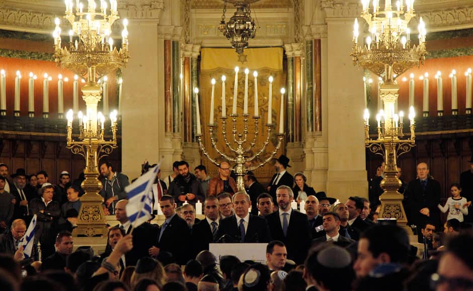 Israel's Prime Minister Benjamin Netanyahu, center, gives a speech during a ceremony at the Grand Synagogue in Paris, France, for all the victims of the attacks in Paris this week, which claimed 17 lives, Sunday, Jan. 11, 2015. More than 40 world leaders, their arms linked, marched through Paris Sunday to rally for unity and freedom of expression and to honor 17 victims of three days of terrorist attacks. AP