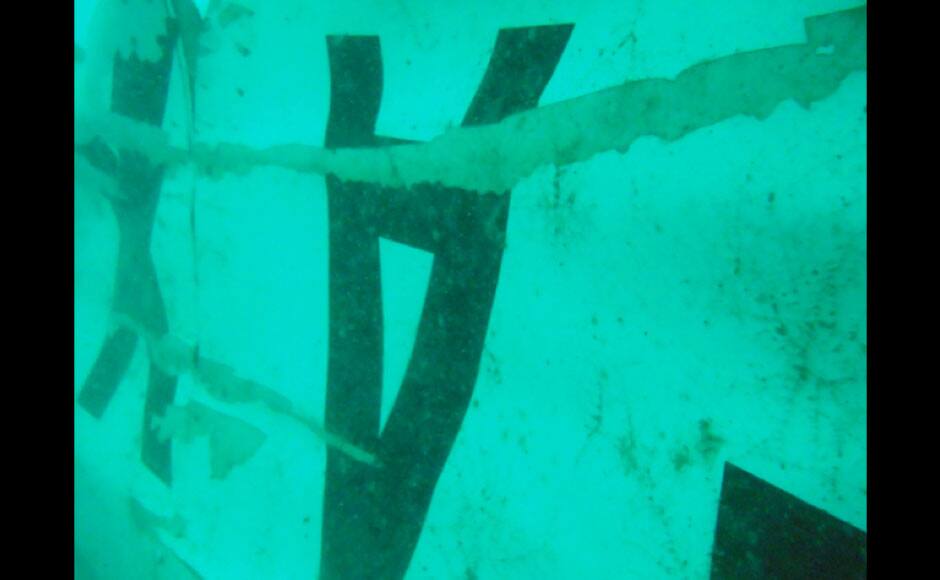 In this undated underwater photo released by Indonesia's National Search And Rescue Agency (BASARNAS) on Wednesday, Jan. 7, 2015, the part of the wreckage that BASARNAS identified as of the ill-fated AirAsia Flight 8501 is seen in the waters of the Java Sea, Indonesia. Divers and an unmanned underwater vehicle spotted the tail of the missing AirAsia plane in the Java Sea on Wednesday, the first confirmed sighting of any major wreckage 11 days after Flight 8501 disappeared with the passengers and crew members on board. (AP Photo/BASARNAS)