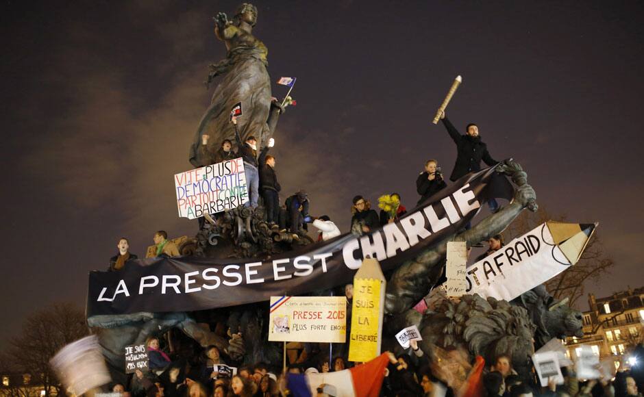 The crowd march in Paris, France, Sunday, Jan. 11, 2015. Hundreds of thousands of people marched through Paris on Sunday in a massive show of unity and defiance in the face of terrorism that killed 17 people in France's bleakest moment in half a century. Banner reads: Press is Charlie. AP