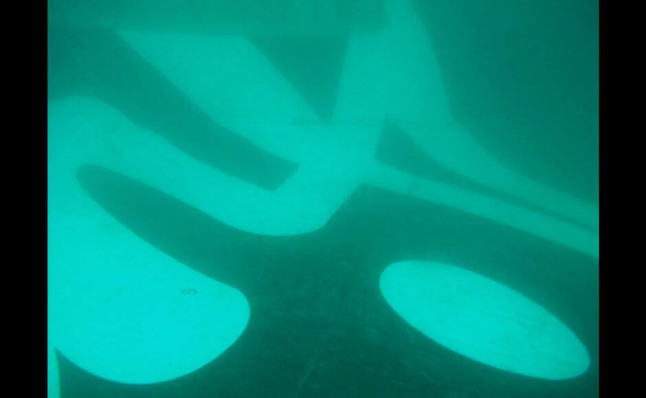 In this undated underwater photo released by Indonesia's National Search And Rescue Agency (BASARNAS) on Wednesday, Jan. 7, 2015, the part of the wreckage that BASARNAS identified as of the ill-fated AirAsia Flight 8501, is seen in the waters of the Java Sea, Indonesia. Divers and an unmanned underwater vehicle spotted the tail of the missing AirAsia plane in the Java Sea on Wednesday, the first confirmed sighting of any major wreckage 11 days after Flight 8501 disappeared with the passengers and crew members on board. (AP Photo/BASARNAS)