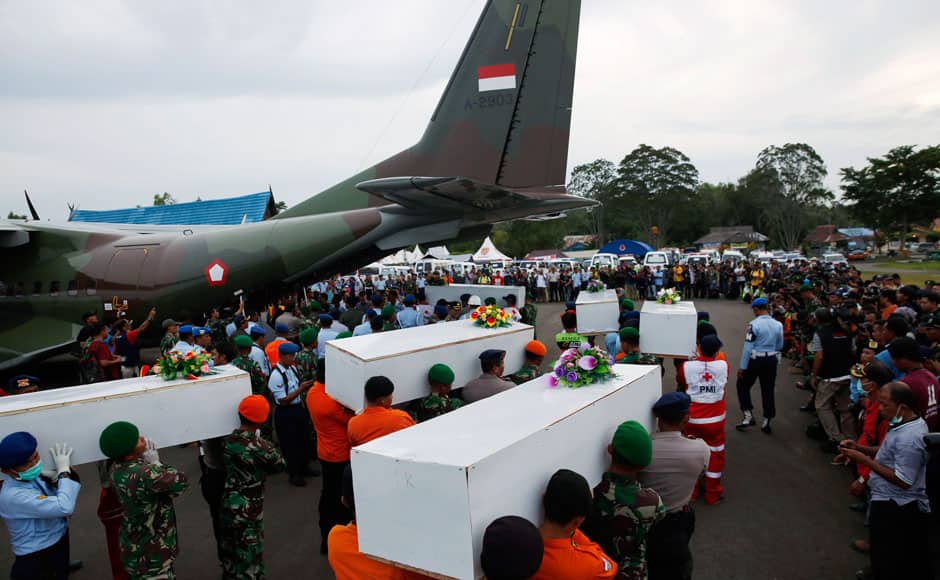 Caskets containing the remains of AirAsia QZ8501 passengers recovered from the sea are carried to a military transport plane before being transported to Surabaya, where the flight originated, at the airport in Pangkalan Bun, Central Kalimantan January 2, 2015. Ships and aircraft criss-crossed the seas off Borneo on Friday hunting for the wreck of the Indonesia AirAsia passenger jet, but bad weather was again hindering the search for the plane and the black box flight recorders that should reveal why it crashed. REUTERS