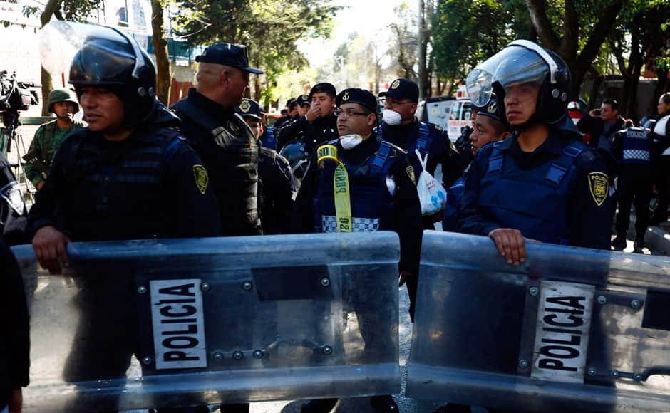 Police stand guard in Mexico City. REUTERS